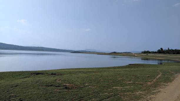 istock Serene lake landscape with distant hills and clear sky. 2183040552