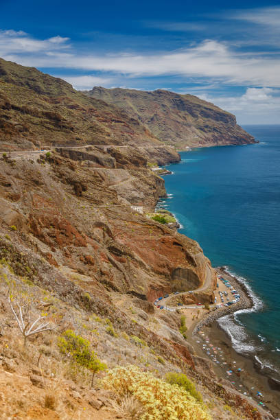 istock Dramatic aerial coastal scene with Playa de las Gaviotas, featuring steep cliffs and dark sand meeting the vibrant ocean in Tenerife 2183043806