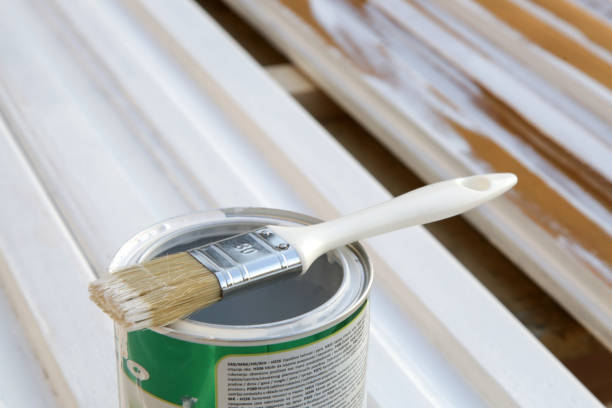istock White paint can with brush on wooden background 2183045695