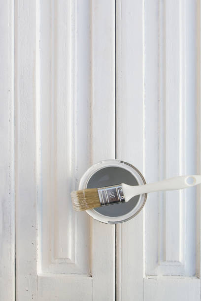 istock White paint can with brush on wooden background 2183045770