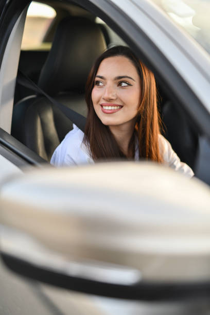 istock Smiling Beautiful Women Driving Car While Enjoying Mesmerizing Sunset 2183049278