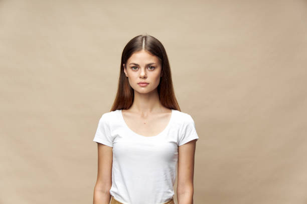 istock Beautiful pensive woman looking charm beige background 2183050524