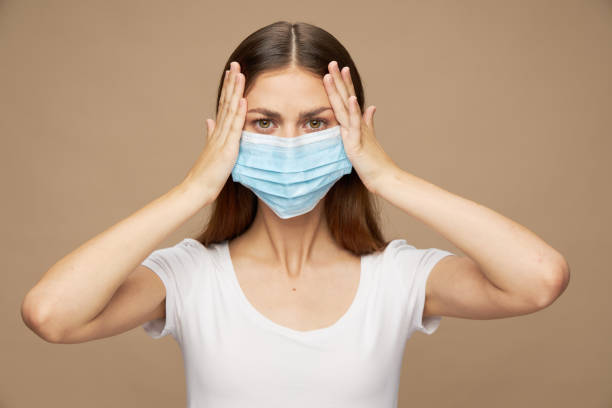 istock Attractive woman in white shirt in a protective mask 2183051276