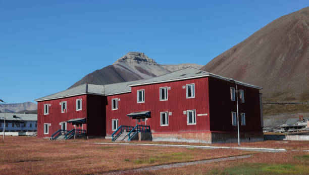 istock Abandoned red building in Pyramiden, Svalbard against a backdrop of mountains 2183051298