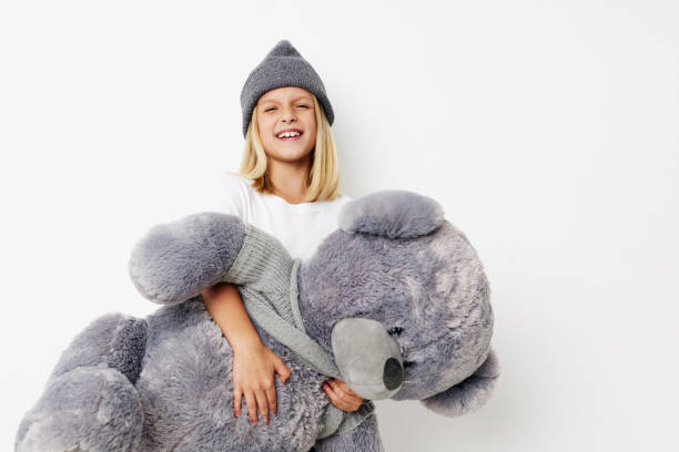 istock happy cute girl fun teddy bear joy on a light background 2183051379