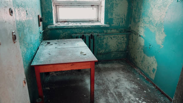 istock Abandoned room in Pyramiden, Svalbard with peeling paint and an empty table 2183052769
