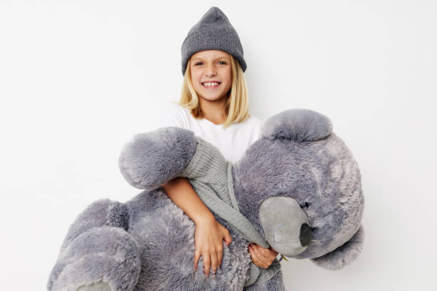 istock happy child with teddy bear a toy isolated background 2183052827