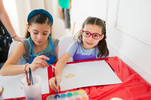 istock Two young girls painting with watercolors during art class at school, developing their creativity and artistic skills 2183053964