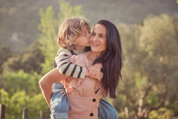 istock Happy mother with son in park 2183055548