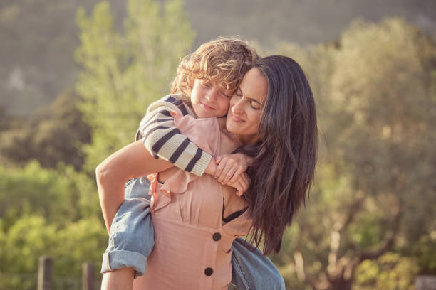 istock Happy mother with son in park 2183055556