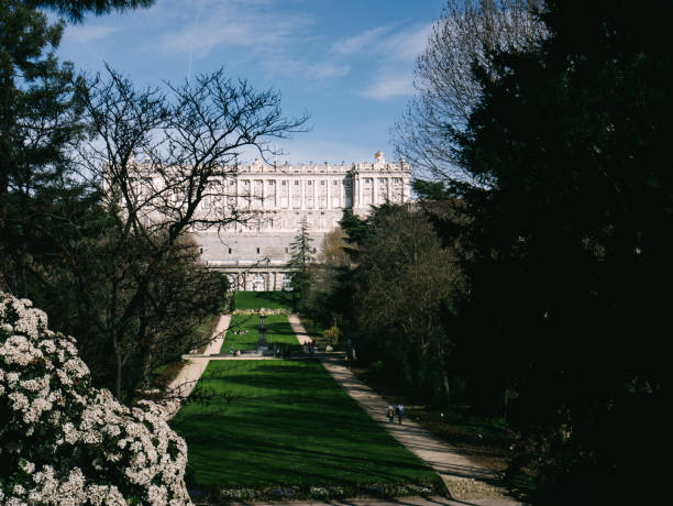 istock Park with green grass and large white building 2183064570
