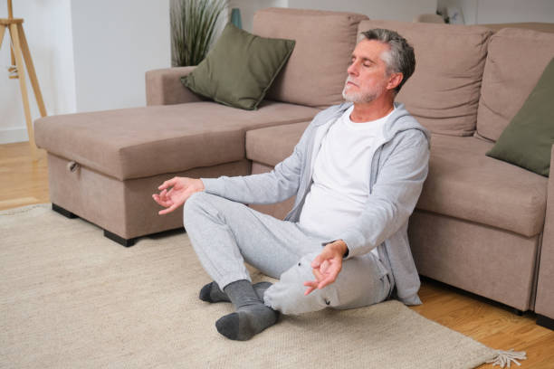istock Senior man meditating in living room, finding inner peace and mindfulness 2183064573