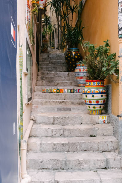 istock Narrow stairway with brightly colored pots and painting 2183064707