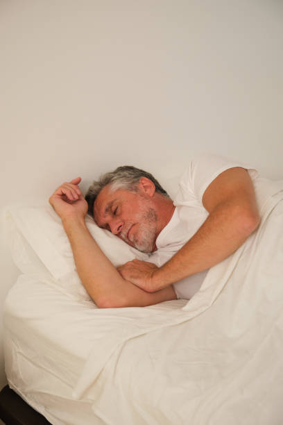 istock Senior man sleeping peacefully in bed, rest and relaxation in retirement 2183065416