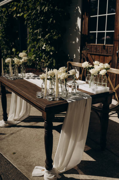 istock An exquisite wooden table with floral decor and candles. 2183066479