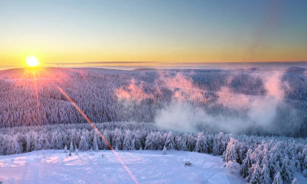 istock sunset over the winter forest with snow covered trees 2183070181