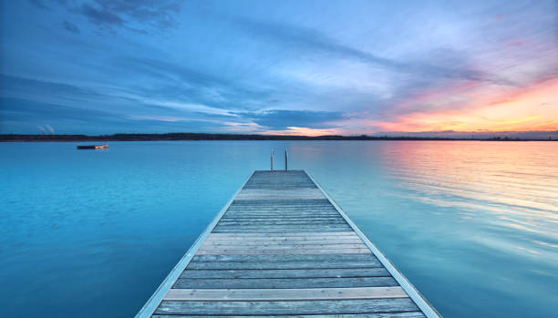 istock wooden boardwalk over the ocean 2183071746