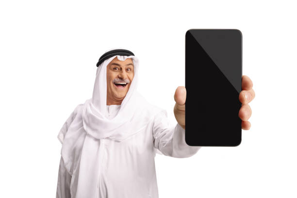 Traditional mature arab showing a smartphone