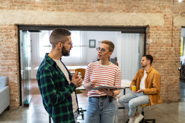 istock Happy business colleagues having casual discussion in the modern office 2183075721