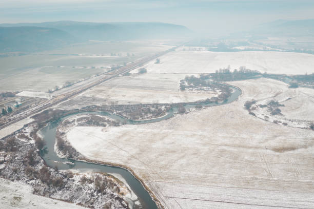 istock Aerial view of a winding river through snowy fields 2183078861