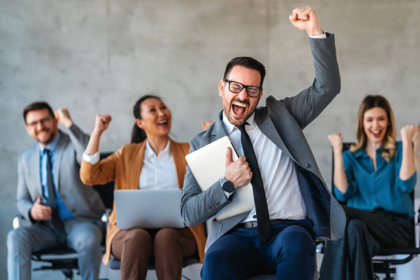 istock Happy businesspeople laughing while collaborating on a new project in an office. 2183078978