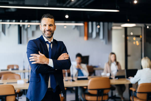 istock Smiling male manager standing in office space 2183079108