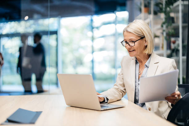 istock Businesswoman working on laptop and paperwork 2183079109