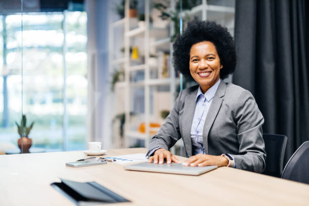 istock Smiling businesswoman at her desk 2183079112