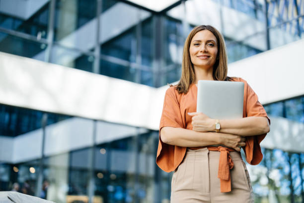istock Smiling professional woman with a laptop 2183079138