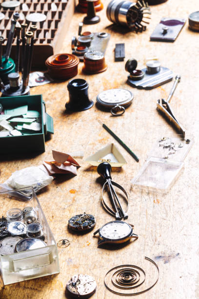 istock Precision tools surround disassembled watches on wood surface 2183079851