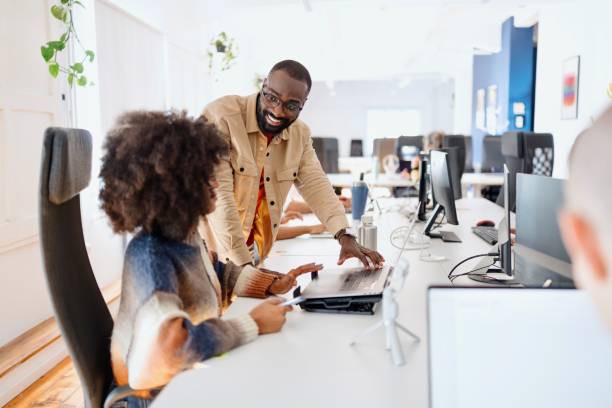 istock Smiling manager talking with his colleague in the office 2183082139