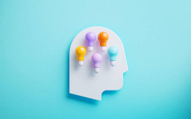 istock Neurodiversity Concept - White Human Head Symbol And Colorful Lightbulbs On Blue Background 2183082472