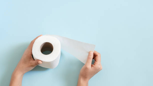 istock Top view of toilet paper roll on blue background 2183083545