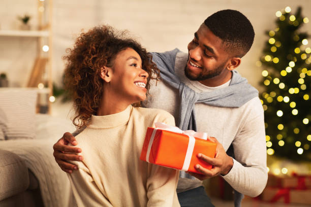 istock Presenting gift as Christmas eve tradition, celebrating New Year 2183083942
