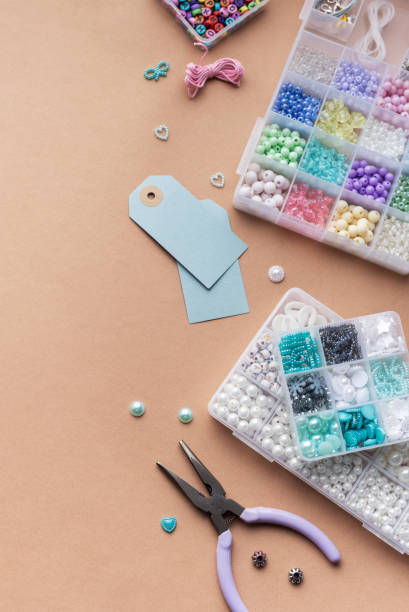 istock Creating personalized crafts with beads and tags on a light background for various DIY projects 2183084260