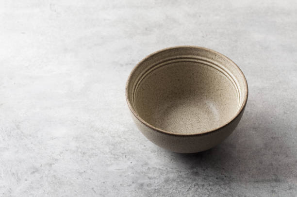 istock Simple empty beige craft ceramic bowl on a gray textured background, mockup, for graphic design, creativity 2183084697