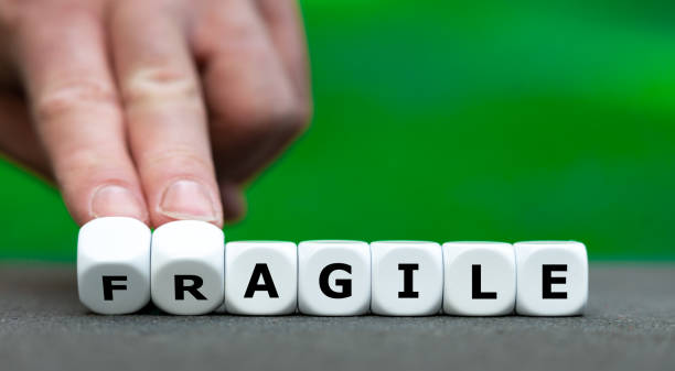 istock Hand turns dice and changes the word 'fragile' to 'agile'. 2183087094