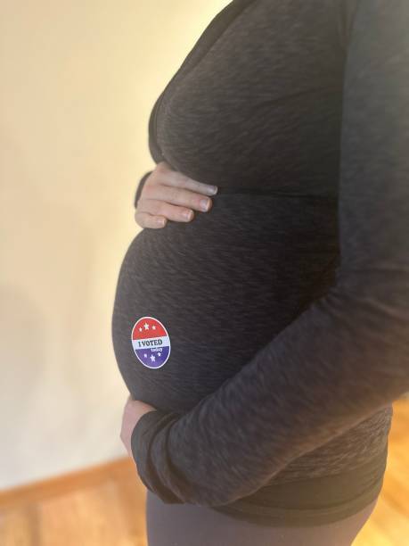 istock Woman with I Voted Sticker 2183088003