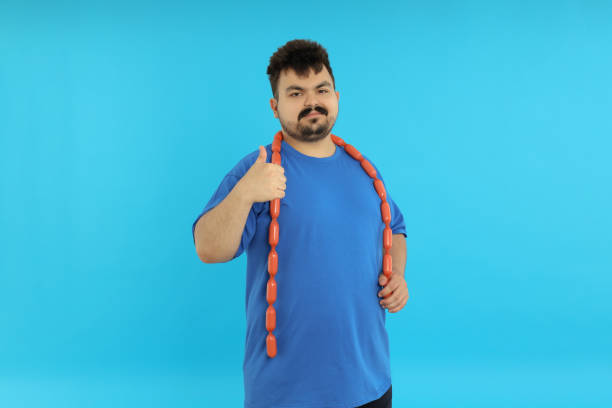 istock Concept of weight problems, young fat man on blue background 2183088255