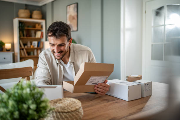 istock Happy young man with a package in his hands, ready to open his online order 2183089368