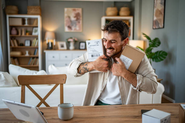 istock Happy young man with a package in his hands, ready to open his online order 2183089516