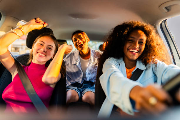 istock Young friends women inside car 2183090813
