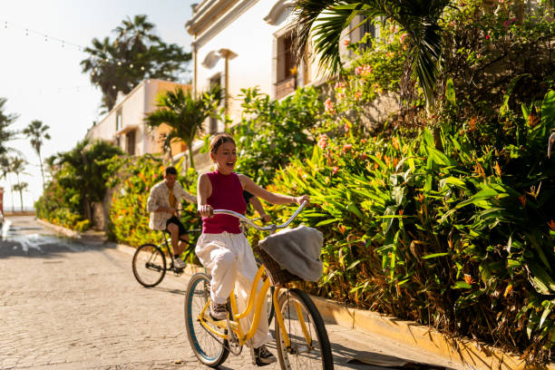 istock Young woman riding bicycle on a historic district 2183091194