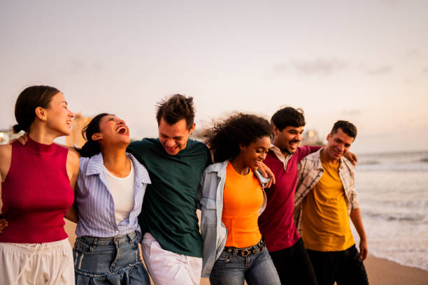 istock Young friends talking and walking on the beach 2183091364