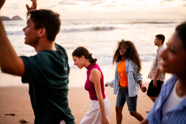 istock Young friends dancing on the beach 2183091504