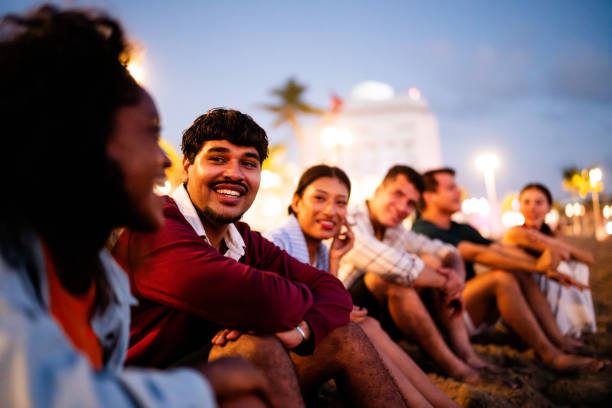 istock Young friends talking on the beach 2183091785