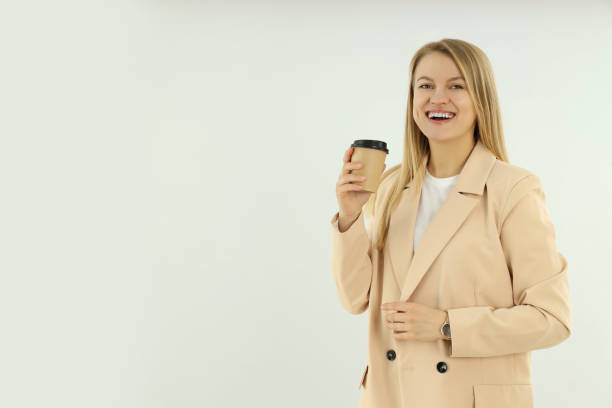 Young and attractive business woman on light background