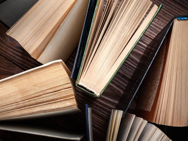 istock Old books . A stack of old open books on a dark background. 2183093198