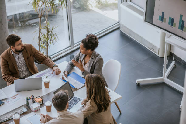 Business professionals collaborate on project during meeting in modern office