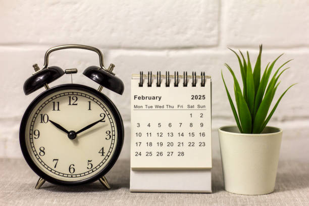 istock Desk calendar for February 2025 and clock on the table. 2183095365